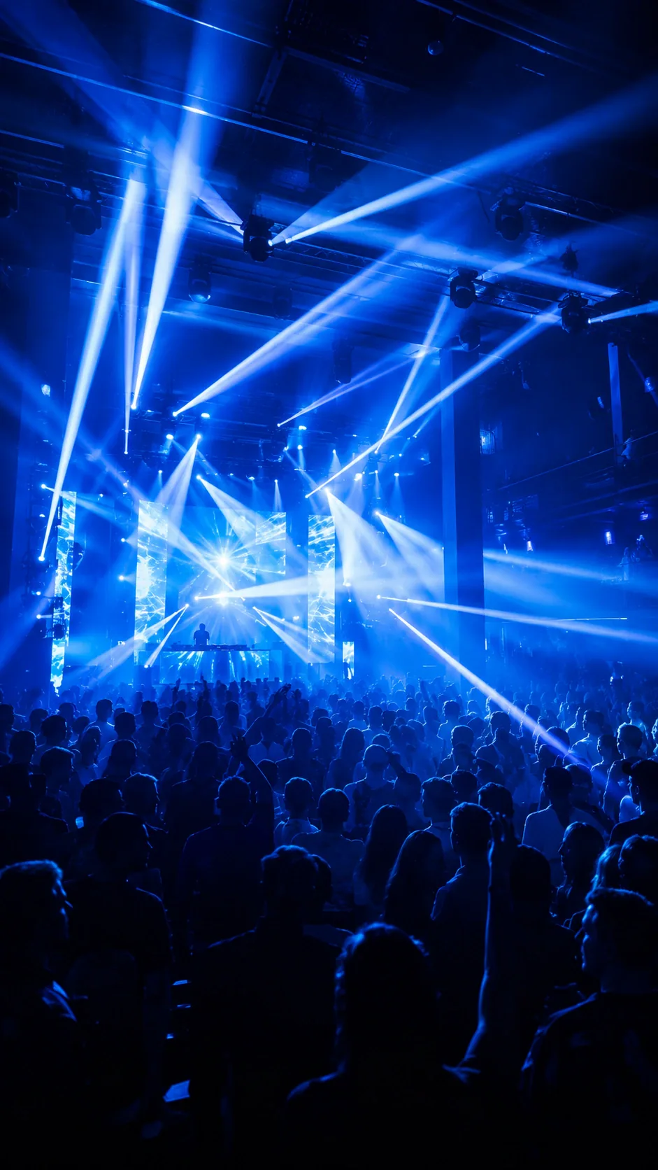 Concert audience under blue stage lighting